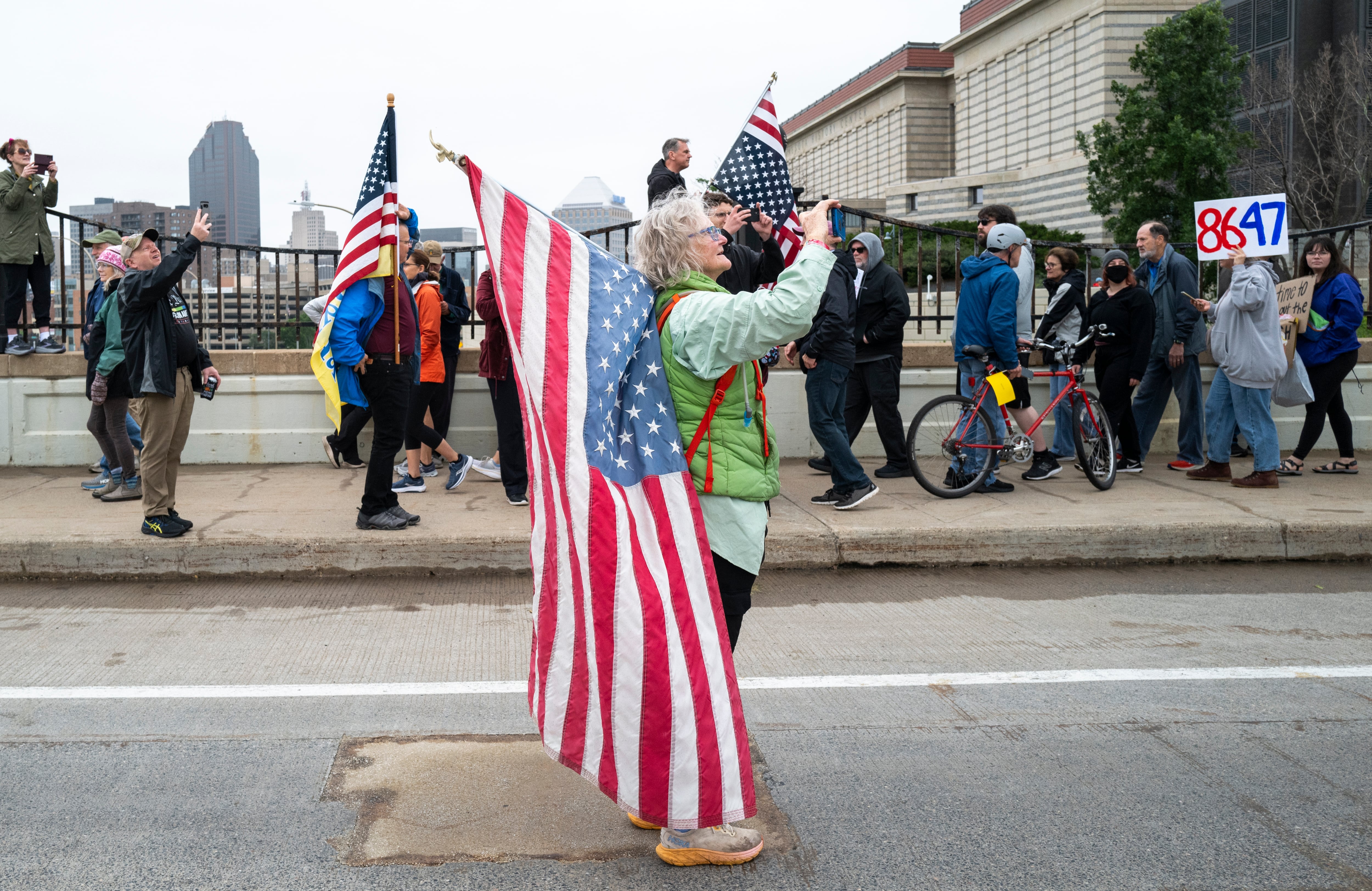 St. Paul: People take photos as demonstrators march to the Minnesota State Capitol building.