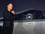 Tesla co-founder and CEO Elon Musk verbally reacts in front of the newly unveiled all-electric battery-powered Tesla Cybertruck with broken glass on windows following a demonstation that did not go as planned on November 21, 2019 at Tesla Design Center in Hawthorne, Calif.