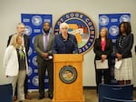Cook County board president Toni Preckwinkle (center) announces the county's debt relief program, along with executives from several local hospitals and Allison Sesso, President & CEO of RIP Medical Debt (far left).