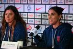 USA forward Alex Morgan (R) speaks beside USA defender Sofia Huerta during a press conference in Auckland, New Zealand on July 25, 2023, ahead of their Women's World Cup soccer match against the Netherlands.