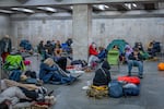 People hide in a metro station, being used as a bomb shelter, during a Russian drones attack in Kyiv, Ukraine, early Friday, Nov. 14, 2025.