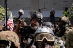 Proud Boy Alan Swinney fires paintballs at antifascist counterprotesters during pro-Trump and pro-police demonstrations  on the 87th day of protests against police violence and systemic racism. Despite violence in the streets, police were notably absent and never declared an unlawful assembly.