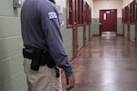 FILE - A security guard poses for a photo next to the group holding cells during a media tour of the Port Isabel Detention Center (PIDC), hosted by U.S. Immigration and Customs Enforcement (ICE) and Harlingen Enforcement and Removal Operations (ERO) in Los Fresnos, Texas, June 10, 2024.