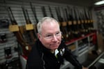 Karl Durkheimer, owner of Northwest Armory gun store in Portland, stands behind the counter Tuesday.