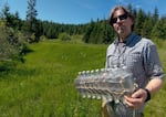 Oregon Fish and Wildlife biologist Simon Wray holds a homemade float consisting of water bottles, string and duct tape. He's been using homemade equipment to study turtles in the Rogue Valley for 23 years.