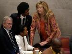 Rep. Justin Jones, D-Nashville, center, Rep. Justin Pearson, D-Memphis, back left and Rep. Gloria Johnson, D-Knoxville, huddle on the floor of the House chamber Thursday, April 6, 2023, in Nashville, Tenn.