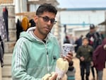 Yousef al-Hindi holds a puppet, also named Yousef, that he created using materials found in his camp in Rafah.