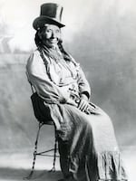 This undated image by photographer Maud Baldwin shows Millie Muster posing for a portrait in a top hat.