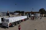 Aid convoy trucks cross the Rafah border from the Egyptian side on Oct. 21, 2023 in North Sinai, Egypt.