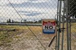 A chain-link fence surrounds the Chemawa Indian School campus.