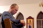 A parishioner prays before the start of Pascha celebrations at St. John the Baptist Ukrainian Orthodox Church.