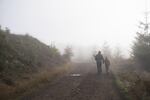 Tyler Tiller and his daughter Taylor walk along a gravel road during the last days of doe season on Oct. 30, 2018 in Drain, Ore. 