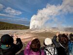 Tourists are seen photographing an eruption of Old Faithful at Yellowstone National Park in this 2011 file photo. On Thursday, a man was killed in an exchange of gunfire with law enforcement park rangers after he was reported to have a weapon and issuing threats, according to the National Park Service.