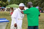 Woodrow Broadnax, known as Mr. Juneteenth, greets a man.