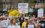 A protester raises a sign reading "Kings Are So 250 Years Ago!" amid crowds gathered at a "No Kings" democracy rally on April 19. 