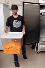 Michael Casper, founder and co-director of Milk Crate Kitchen, begins food preparation for the organization. Casper started making free meals for people out of his own kitchen in 2020 and eventually turned the operation into a nonprofit.