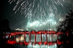 Revellers watch the New Year's Eve fireworks from the The Huc Bridge at Hoan Kiem Lake in Hanoi 