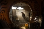 Palestinians look at their neighbor's damaged home following an Israeli strike in Rafah, a city in southern Gaza, on Jan. 27.