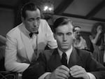 A screenshot from Casablanca showing Humphrey Bogart and Helmut Dantine.