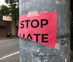 A torn "Stop Hate" sign that was previously hung up in downtown Eugene (file photo).