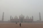 People visit Badshahi Mosque amid heavy smog in Lahore on November 9. The government has ordered public spaces to close closed in smog-hit main cities as the country battles record air pollution. (Photo by Syed MURTAZA / AFP) (Photo by SYED MURTAZA/AFP via Getty Images)