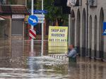 A man stands in waist-deep water that has flooded the streets and houses in the town of Kłodzko, in Poland's southwest, on Sunday.