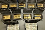 This image provided by U.S. Department of Justice, and contained in a court filing, shows gold bars and cash that was seized from a David J. Rush's home, during a search on May 19, 2026, in Ashburn, Va.