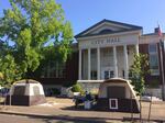 People experiencing homelessness camp in tents on the sidewalk in front of Corvallis City Hall.