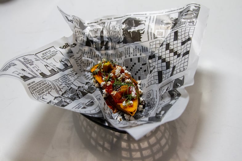 The "Three Sisters Baked Potato" is vegan and gluten free. Ingredients include sweet potato, black tepary beans, birch syrup, apples, wild leeks, smoked pinon and popped sorghum, topped with a rosehip chile sauce.