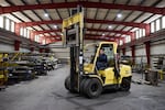 Thomas Van Hoose operates a forklift to move a piece of steel while working at Swift Steel.