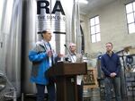 Senator Ron Wyden and Congressman Earl Blumenauer tout the benefits of the new Cider Act at Reverend Nat's Hard Cider brewery in Northeast Portland.