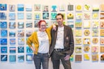 Abby Dubief and Stuart Breidenstein are the co-founders of the 20-Dollar Art Show, an annual event held in Bend that features thousands of original pieces of artwork available to buy for just $20 each. Dubief and Breidenstein are shown in this photo posing in front of a wall of some of the pieces submitted by artists participating in last year's show which opened on October 28, 2022 at the High Desert Museum.