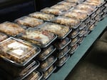 The Portland food salvage and redistribution nonprofit Milk Crate Kitchen delivers more than 100 meals to an overflow emergency shelter at Clackamas Community College on Wednesday in Oregon City, Ore. The nonprofit's founder Michael Casper said he was able to deliver the meals through icy conditions in part because of his trusty red Subaru.