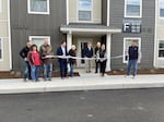 Talent Mayor Darby Ayers-Flood cuts the ribbon to signify the grand opening of Renaissance Flats on Nov. 29, 2023.