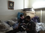 Lebanese Popular Relief Association, prepares school clothes for displaced Lebanese children with one of his colleagues in their office in Beirut, Lebanon.