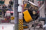 Emergency teams work at the site of a derailed electric streetcar in Lisbon, Portugal on Wednesday.