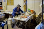 Pooka Rice sorts and records the trash found during a monthly marine debris survey. She then separates any usable materials into color-coded bins to use as art materials for the jewelry and art program she started called Trash Talk. 