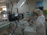 A Palestinian doctor treats a prematurely born baby at Al Aqsa Hospital in Gaza on Sunday, Dec. 10, 2023.