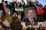 People hold a banner featuring Turkish President Recep Tayyip Erdogan as members of the Syrian community and supporters gather in Istanbul to celebrate the fall of Syrian President Bashar al-Assad in the face of an offensive by Islamist-led rebels, on Dec. 8.