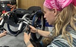 An attendee looking at a wheelchair in an undated provided image.