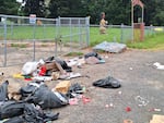 The entrance to the Chemawa Cemetery, photographed on May 22, 2024, was littered with mounds of trash and a tattered old mattress. "This is heartbreaking," said John Spence.