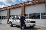 Jessica Marcum is a community paramedic with the Umatilla County Fire District #1 serving patients in Umatilla and Morrow counties. This photo of her standing next to the vehicle she uses for at-home visits to patients was taken in April 2022 at the fire district station in Hermiston.