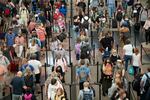 FILE - In this Wednesday, June 16, 2021 file photo, travelers queue up in long lines to pass through the south security checkpoint at Denver International Airport, in Denver. This summer is already shaping up to be a difficult one for air travelers as airlines are already struggling to keep up with the rising number of passengers.