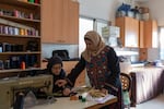 Hanan Zarura (right) gives instructions to an employee at the sewing workshop at Beit Atfal Assumoud, on Dec. 2, 2024.