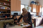 Hanan Zarura (right) gives instructions to an employee at the sewing workshop at Beit Atfal Assumoud, on Dec. 2, 2024.