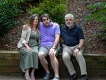 Ramirez sits with son Ryan (center) and husband Dan Crimmins. Stacey and Dan are both professional disability consultants who work with other families on applying for SSI benefits — but they had difficulty making SSI work for Ryan.