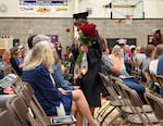 Senior Greta Fillible hands a rose out during graduation at Perrydale High School on June 6, 2026 in Amity, Ore. Perrydale is one of 19 Oregon school districts with a 100% graduation rate in 2025.