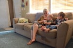 Anastazia Burnett with her two children in their home in Waterville, Washington.