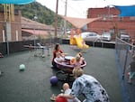 Staff and toddlers play at a daycare in Williamson, W.Va. in September.