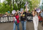 (Left to right) Maya Malka, 17, JJ Klein-Wolf, 15, and Dana Savage, 15, lead thousands of area youth climate activists and supporters on a march through downtown Portland, May 20, 2022, as part of a youth-led climate mobilization demanding city leaders take meaningful action on climate change.